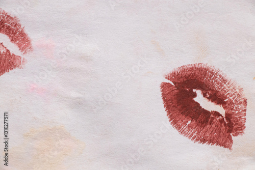 Maroon lipstick kiss mark on white old paper, kiss