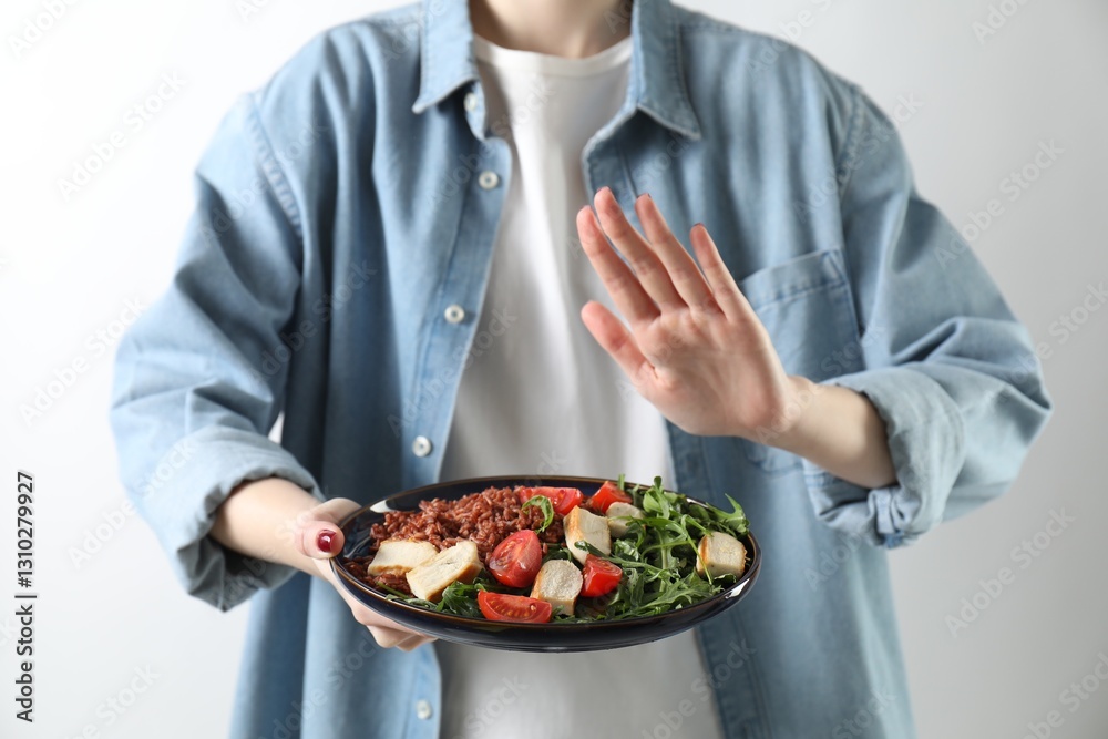 Woman refusing to eat meal on white background, closeup. Food allergy concept Woman refusing to eat meal on white background, closeup. Food allergy concept