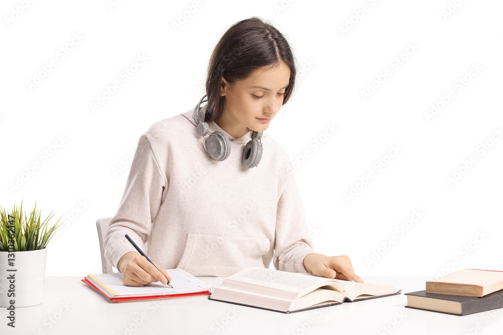 Teenage female student studying on a desk Teenage female student studying on a desk