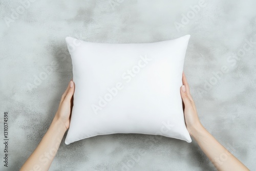 Mockup Hands Holding a Pillow on a Gray Textured Background