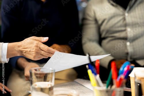 Businessmen in office looking through financial business files. Close up shot of men in workspace checking accounting figures, finishing tedious paperwork, debating about data photo