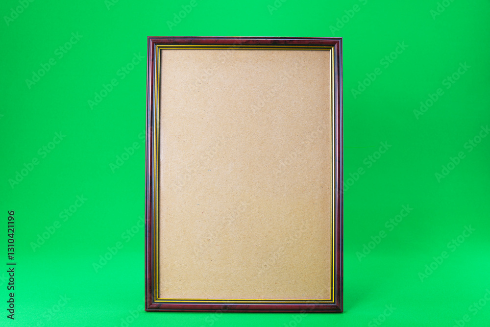 Fototapeta premium Wooden frame on a green background