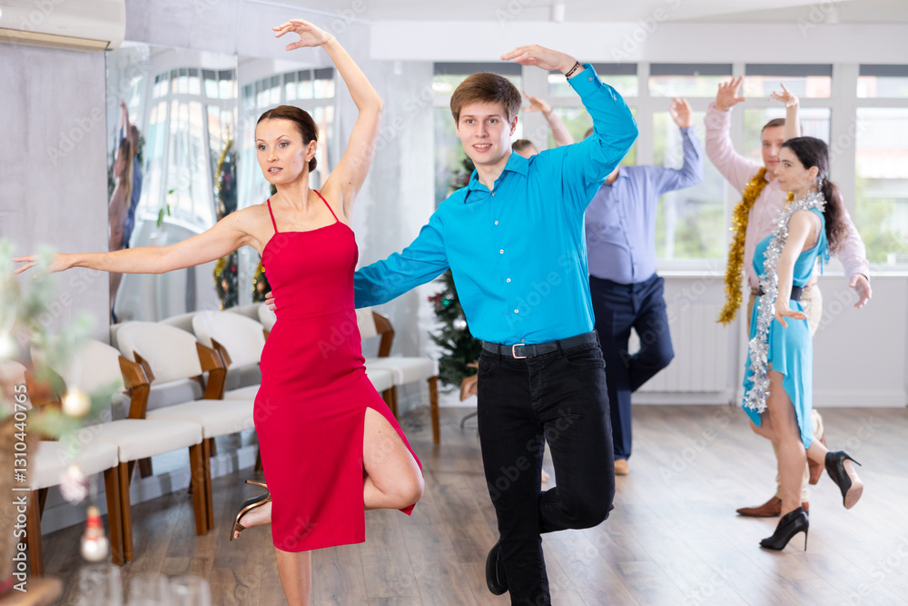 Fototapeta premium Adult woman and young man dancing in dance class