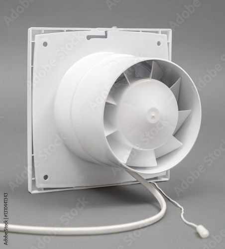 White fan on a gray background. Ventilation system. Back view. Rope of the switch.