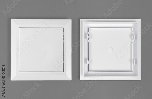 White plastic hatch on a gray background. Square shape. Top view.