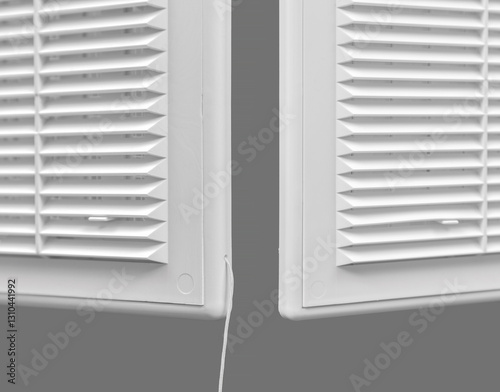 White ventilation grate on a gray background. Close-up. Material is plastic.
