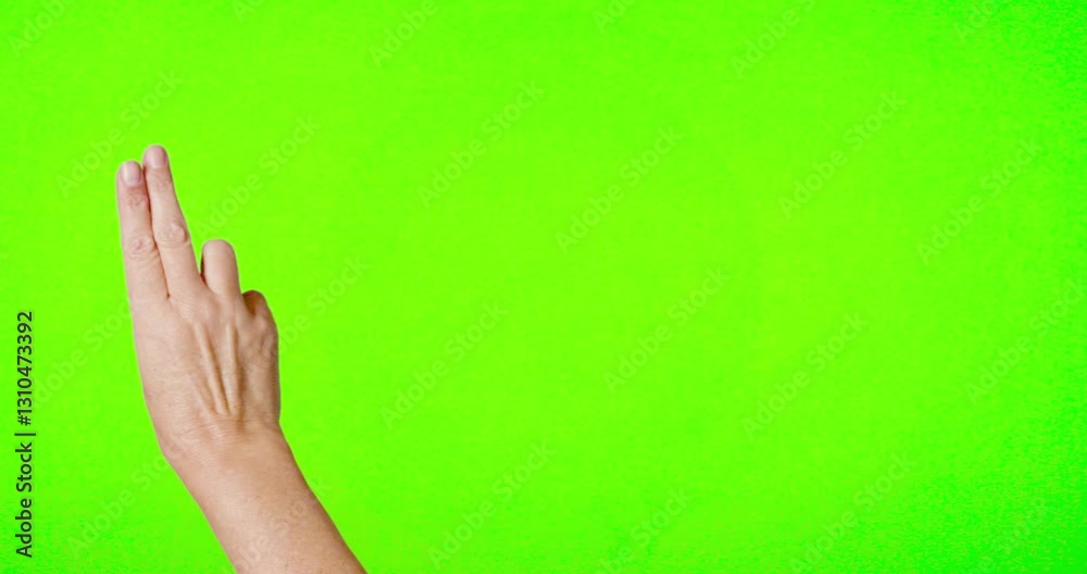 Female Hand Swiping Back and Forth on Chroma Key Green Screen.
