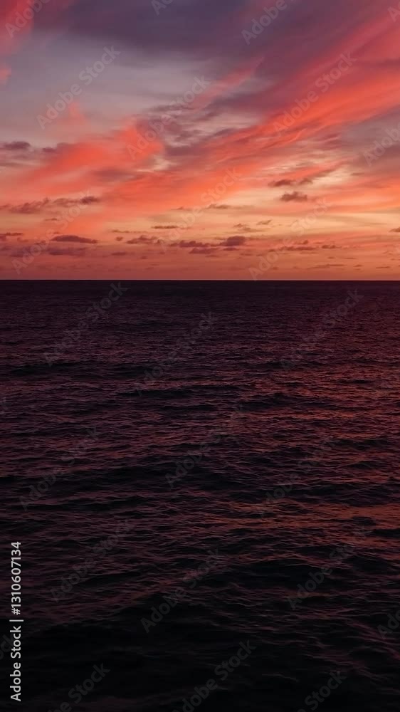 Bright and colorful sunset sky reflecting on the calm ocean waters, with a distant horizon. Seychelles, Mahe. Bright and colorful sunset sky reflecting on the calm ocean waters, with a distant horizon. Seychelles, Mahe.
