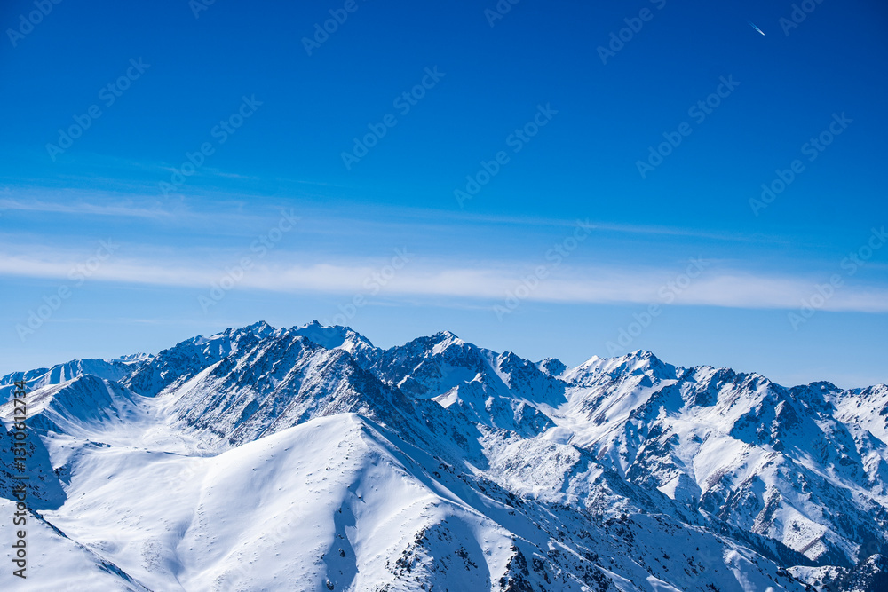Fototapeta premium Snowy mountain peaks not far from Almaty, mountain views from kumbel peak. A popular tourist route in the mountains.
