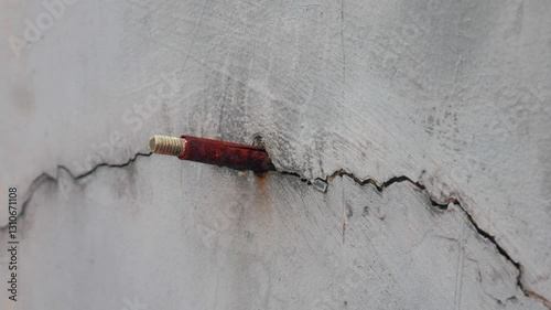 single line crack in the wall, nail stuck in the wall.