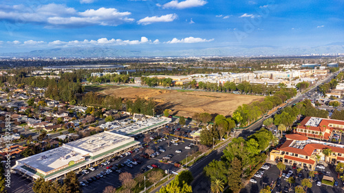 Aerial view of demolished Vallco shopping mall in Cupertino, California, surrounded by residential and commercial buildings in March 2025. Apple Park and Main Street Cupertino shopping mall.