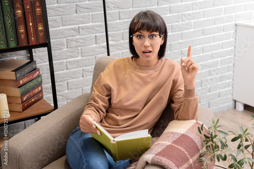 Young woman with book point...