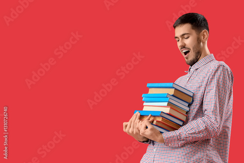 Young man with stack of boo...