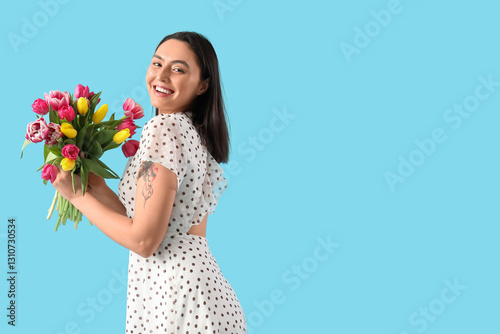 Happy young woman with bouq...