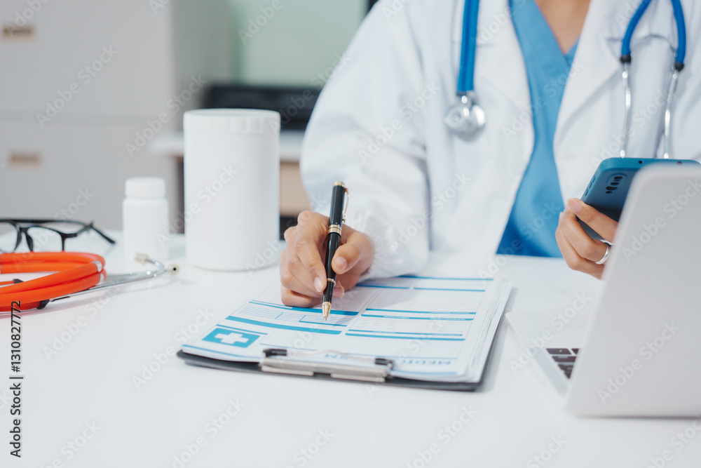 Asian female doctor is reviewing medical records, working on a computer, planning treatment, giving online consultations, and explaining medications to patients via a medical video call in a clinic