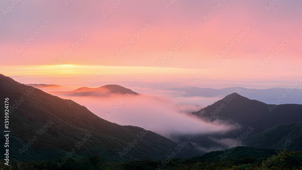 A breathtaking view of a misty mountain range at sunrise A breathtaking view of a misty mountain range at sunrise