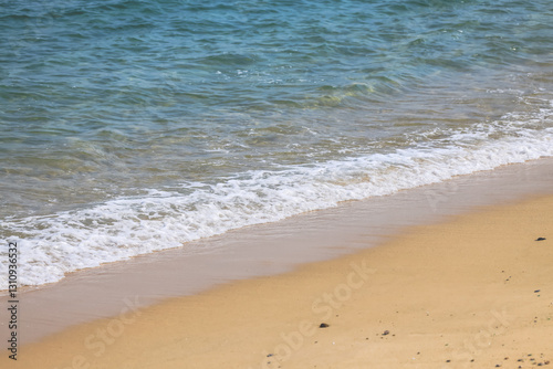 Dec 28 2024 Sandy Beach with Gentle Ocean Waves on a Sunny Day photo