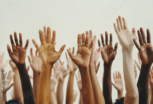 Many hands reach up in the air, belonging to a diverse group with different skin tones, against a white background, creating an emotional and uplifting atmosphere.
