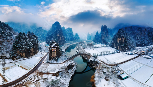 Winter Wonderland: A breathtaking panorama of a snow-covered landscape, with towering, majestic mountains and a winding river creating a serene winter ambiance.