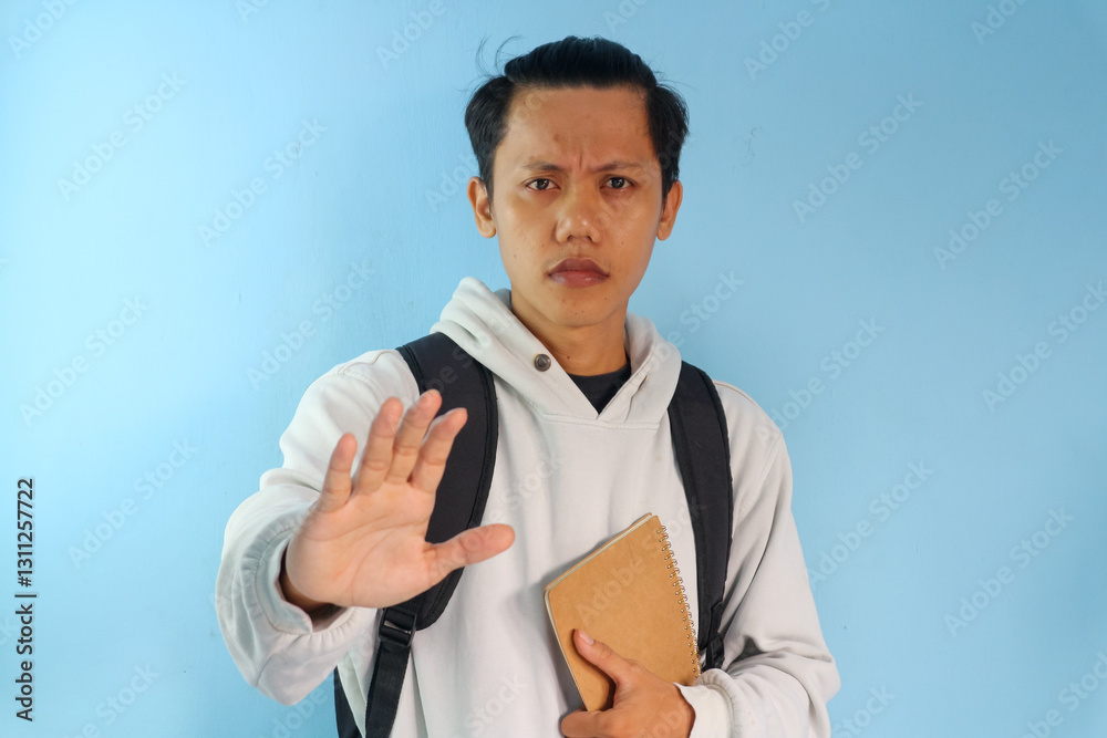 Asian male student college doing stop gesture with hand Asian male student college doing stop gesture with hand