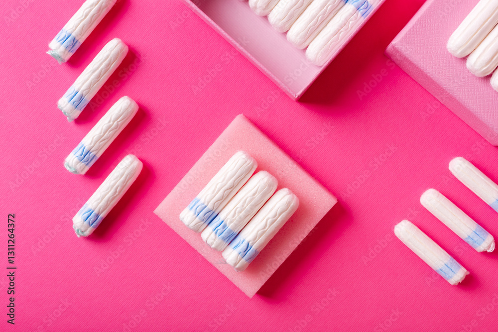 Many menstrual hygiene tampons from above on pink background in beautiful composition. Soft cotton absorbent menstrual tampons for women during menstruation. Feminine hygiene. Many menstrual hygiene tampons from above on pink background in beautiful composition. Soft cotton absorbent menstrual tampons for women during menstruation. Feminine hygiene.
