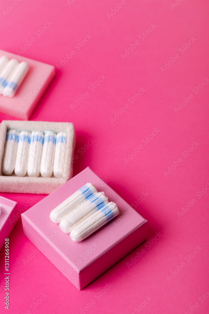 Many menstrual hygiene tampons from above on pink background in beautiful composition. Soft cotton absorbent menstrual tampons for women during menstruation. Feminine hygiene. Many menstrual hygiene tampons from above on pink background in beautiful composition. Soft cotton absorbent menstrual tampons for women during menstruation. Feminine hygiene.