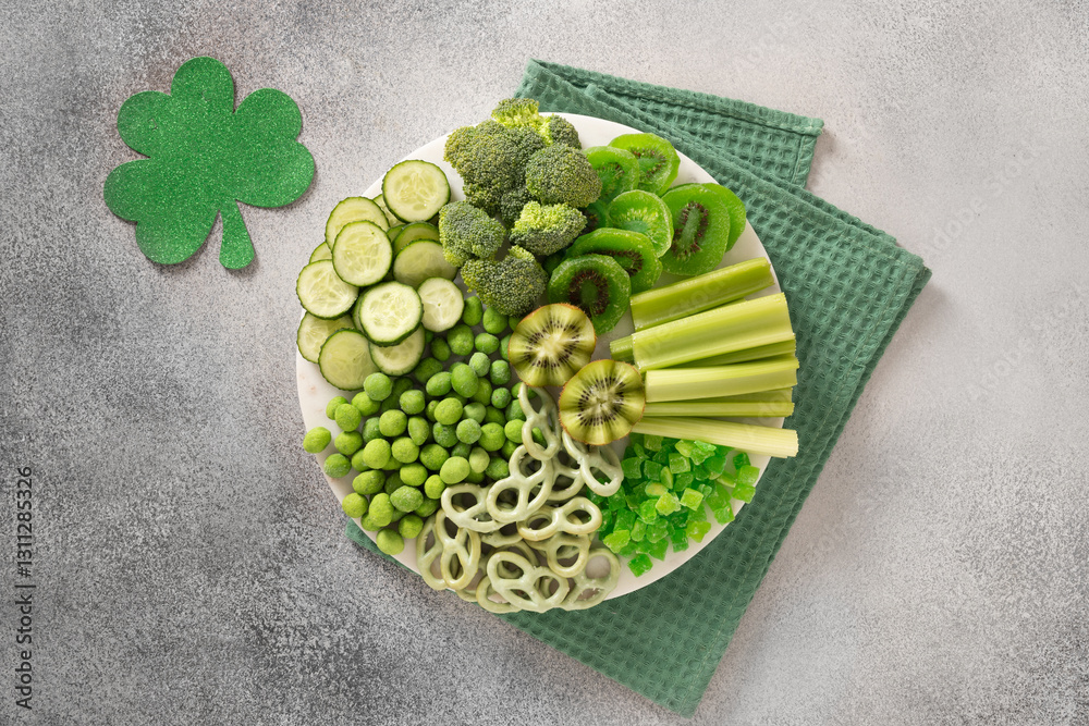 St Patricks day with charcuterie board decorated shamrock and clover leaf on gray background. View from above. Festive holiday appetizer for celebration.