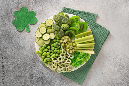 Obraz na płótnie St Patricks day with charcuterie board decorated shamrock and clover leaf on gray background. View from above. Festive holiday appetizer for celebration. w salonie