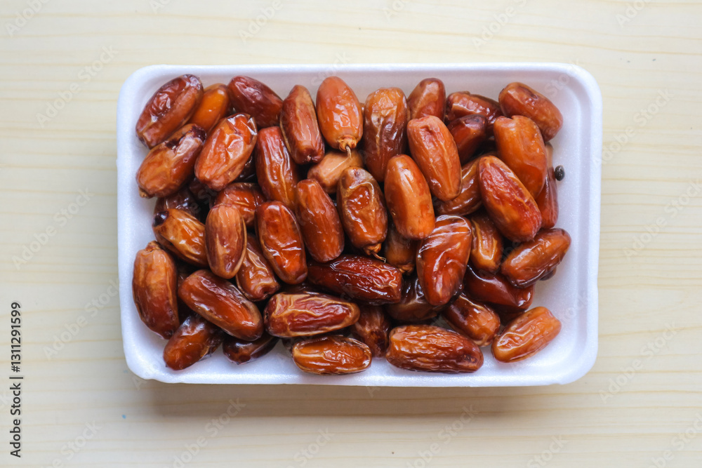 Kurma Tunisia or Tunisia dates, sweet dried dates palm fruits. on wooden table Kurma Tunisia or Tunisia dates, sweet dried dates palm fruits. on wooden table