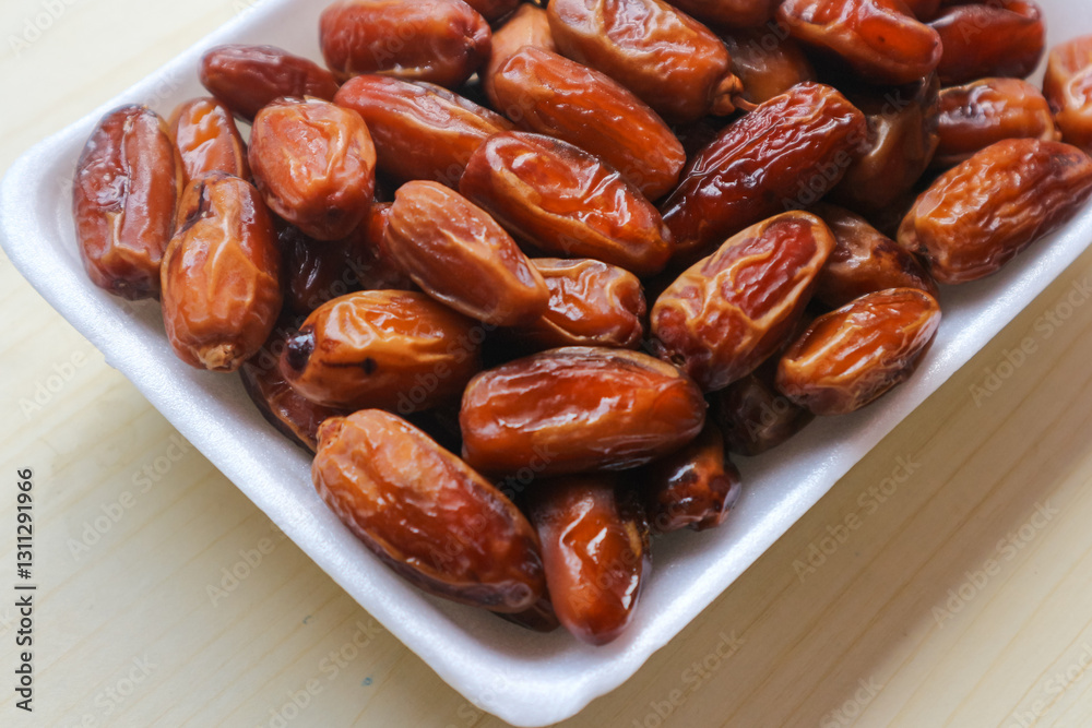 Kurma Tunisia or Tunisia dates, sweet dried dates palm fruits. on wooden table Kurma Tunisia or Tunisia dates, sweet dried dates palm fruits. on wooden table