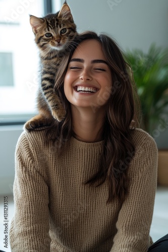 Smiling woman enjoys cozy moment with playful cat on her shoulde