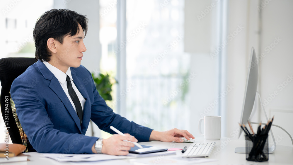 Businessman sitting and working in an office Businessman sitting and working in an office