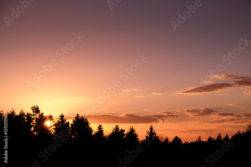 Beautiful sunset above forest in Franconia. Seen in Germany in March.
