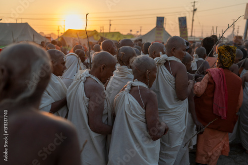  27 pJanuary 2025 After completing all the rituals female Naga Sadhus in white clothes stand in a line and go towards their tents at the Kumbh Mela in Prayagraj or Allahabad Uttar Pradesh India