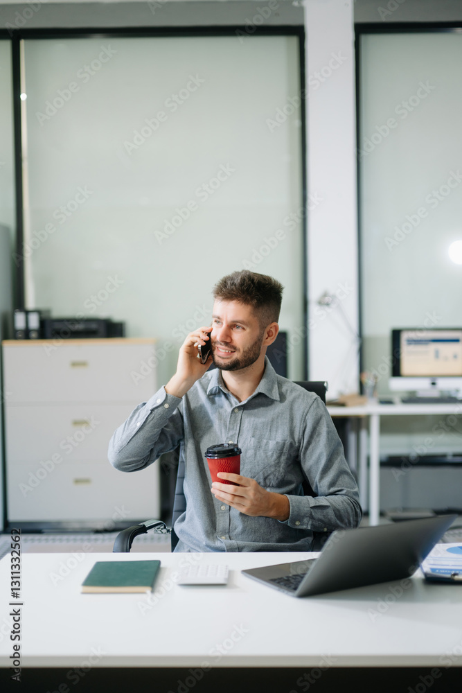 Confident businessman working on finance analysis with a tablet and laptop at office desk.  professional workplace concepts..