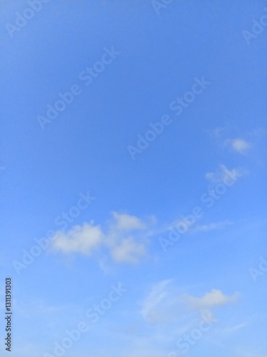 Bright Blue Sky with Scattered Thin Clouds