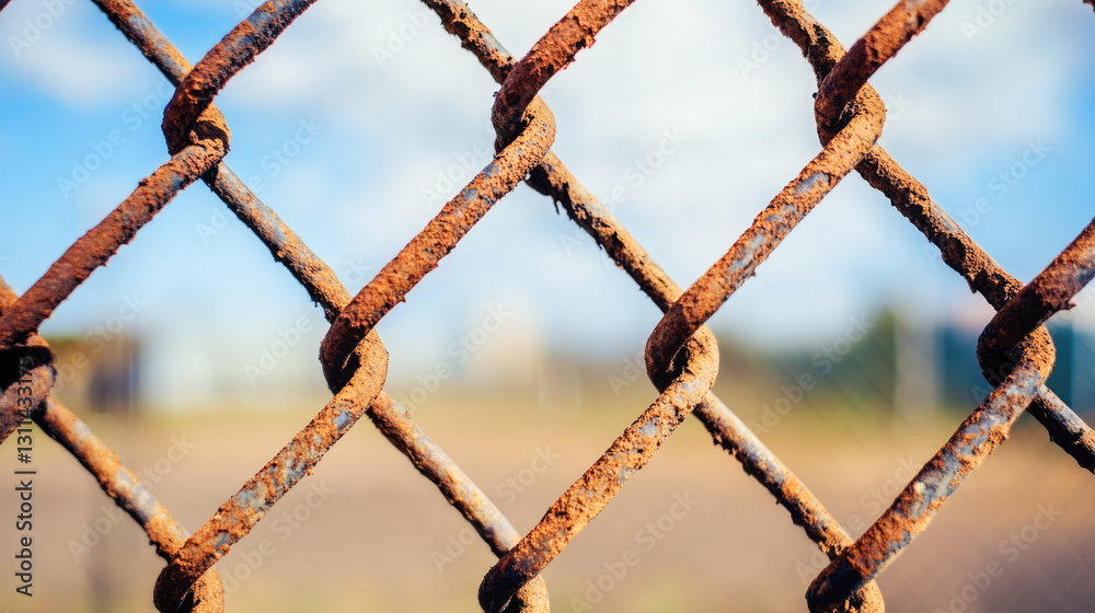 Close-up of rusty metal fence with blurred background Close-up of rusty metal fence with blurred background