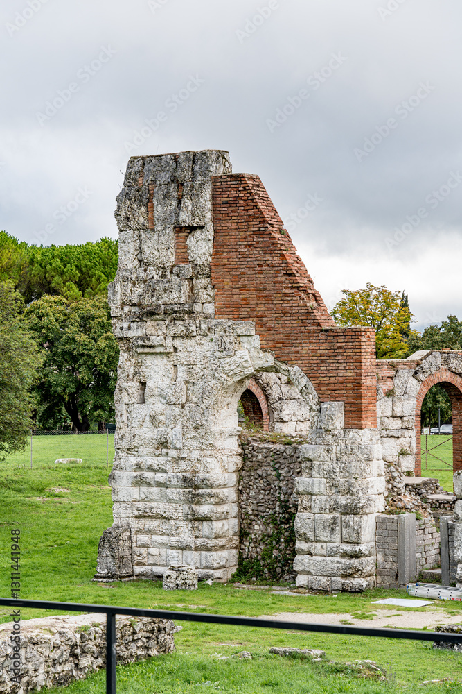 A large stone building with arched windows and a courtyard in Gubbio Italy Umbria. Archaeological Park of the Roman Theater in Gubbio A large stone building with arched windows and a courtyard in Gubbio Italy Umbria. Archaeological Park of the Roman Theater in Gubbio