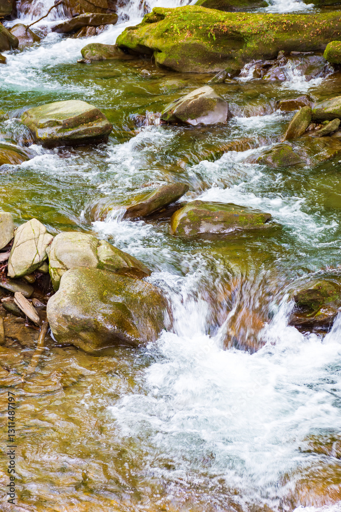 rapid water stream among rocks and stones. beautiful nature background in romanian mountains. closeup view from above