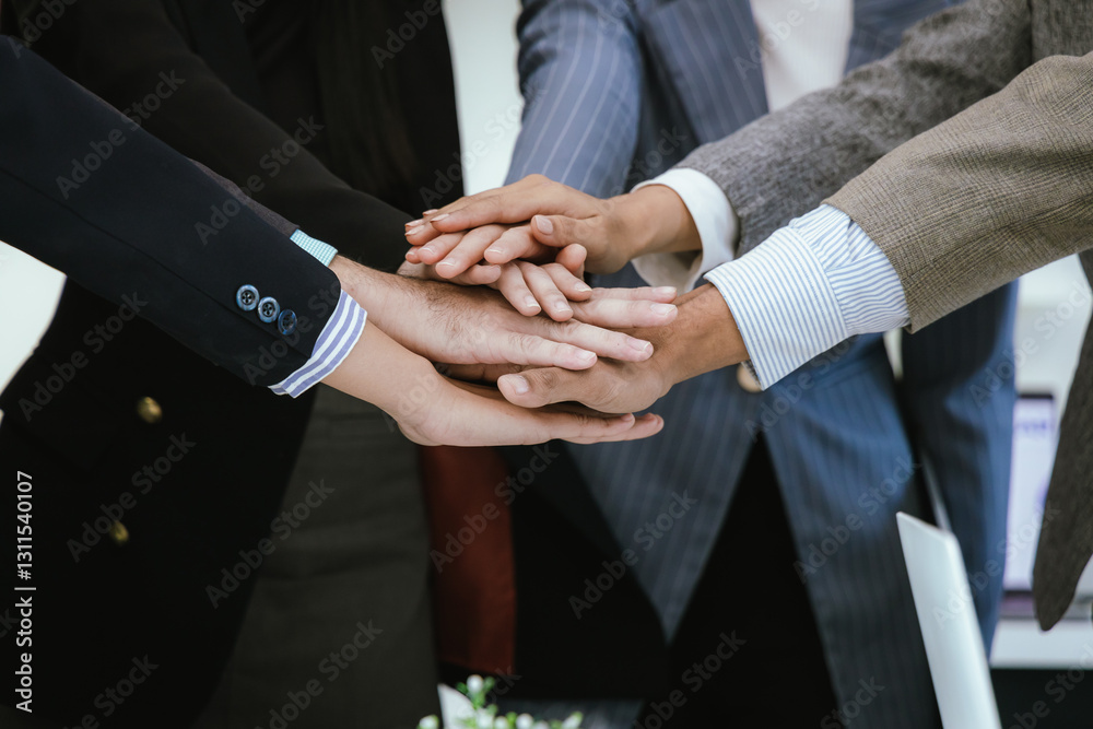 A team of professionals work together in an office to analyze financial charts, market strategies and work as a team to drive business growth and success.