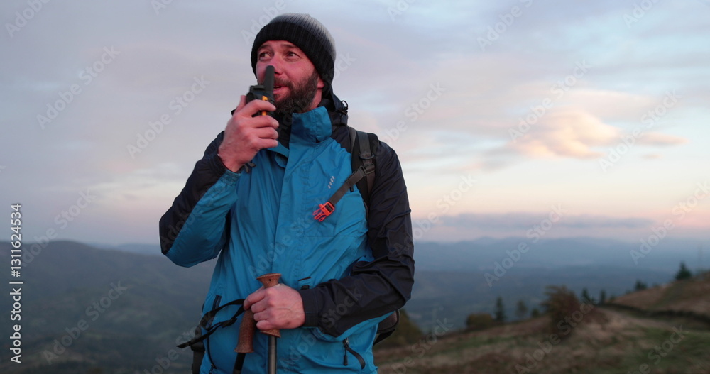 custom made wallpaper toronto digitalA lone hiker stands on a mountain peak, communicating via a pocket radio. Dressed in sports gear, he surveys the vast landscape, relaying messages against a backdrop of misty peaks and deep valleys.