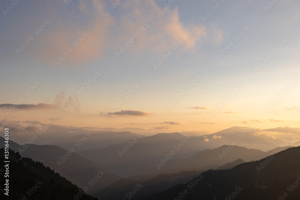 Silhouette of the hazy mountain ranges with fog at sunset. Silhouette of the hazy mountain ranges with fog at sunset.