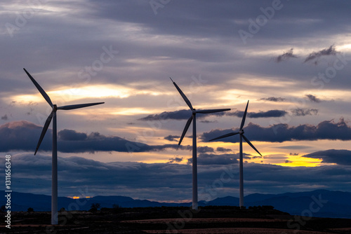 Multiple wind turbines generating power at sunset, Zaragoza, Spain, sustainable energy.