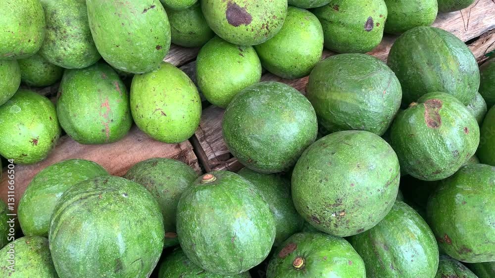 Close-up of Fresh Green Avocados Stacked on Wooden Crate at Market Close-up of Fresh Green Avocados Stacked on Wooden Crate at Market