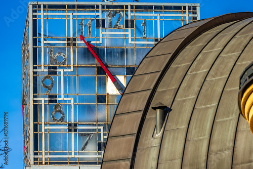 An old clock on a high tower against the blue sky, the clock face on the town hall tower Czestochowa