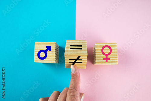 Gender equality symbol. Hand turns cube and changes inequality sign to equal sign between male and female symbols. Nice pink and blue background