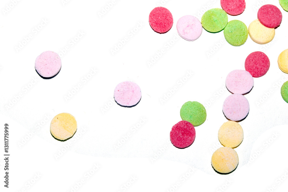Close up of sugar paper confetti circle spots and colour dots on white background Close up of sugar paper confetti circle spots and colour dots on white background