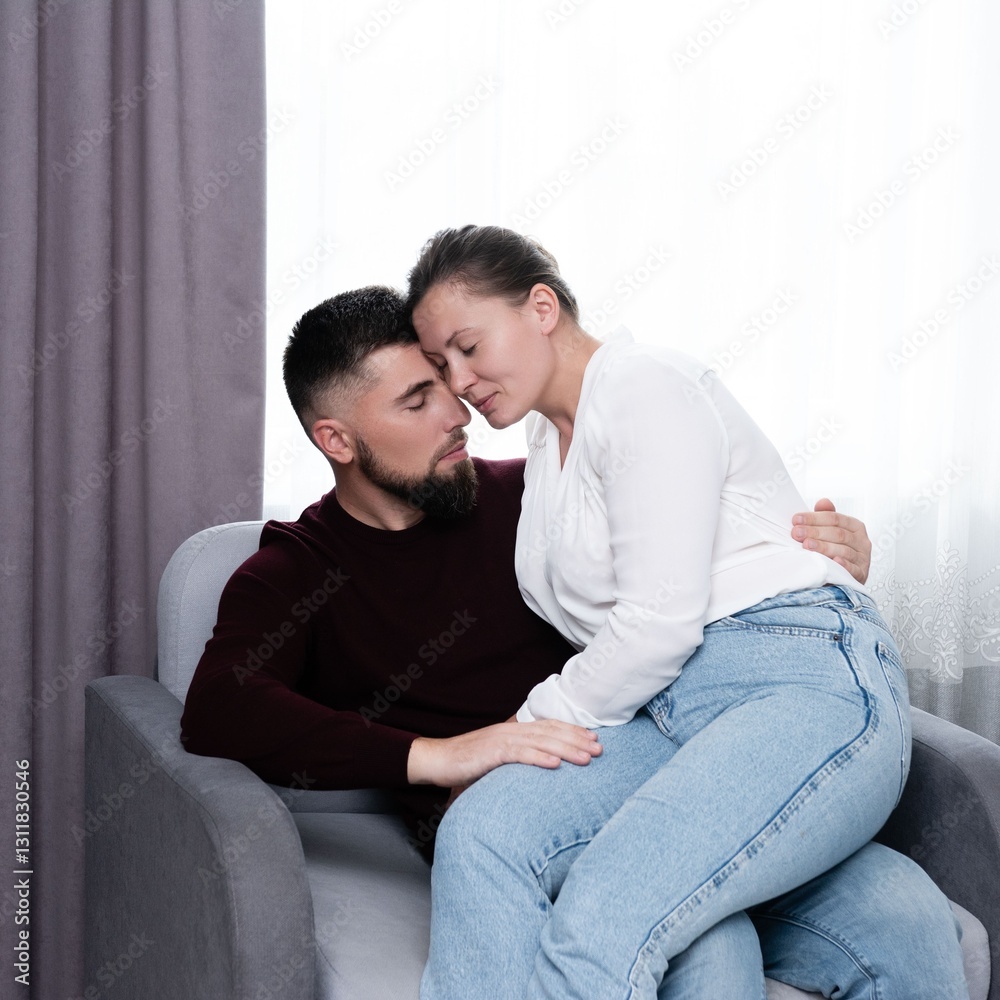 Couple embracing tenderly on a cozy couch in soft light, sharing a moment of intimacy and connection in their private space during a serene afternoon Couple embracing tenderly on a cozy couch in soft light, sharing a moment of intimacy and connection in their private space during a serene afternoon