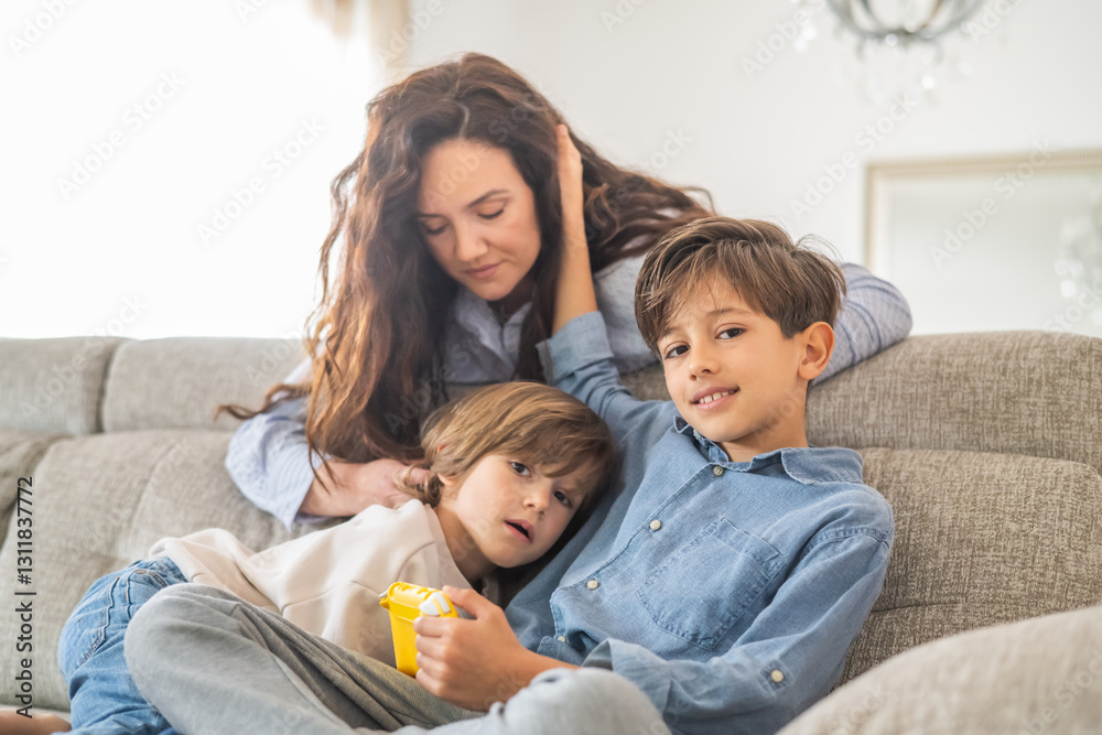 Two brothers and their mother are sitting on a comfortable sofa in their living room, enjoying quality time together playing video games, creating a warm and loving family atmosphere Two brothers and their mother are sitting on a comfortable sofa in their living room, enjoying quality time together playing video games, creating a warm and loving family atmosphere