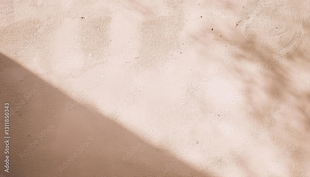 Fototapeta premium soft beige stucco wall with diagonal sunlight shadows and small imperfections, ideal for minimalist background and texture
